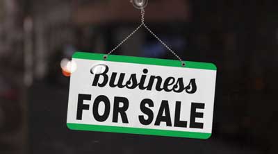 Business for sale sign in a window